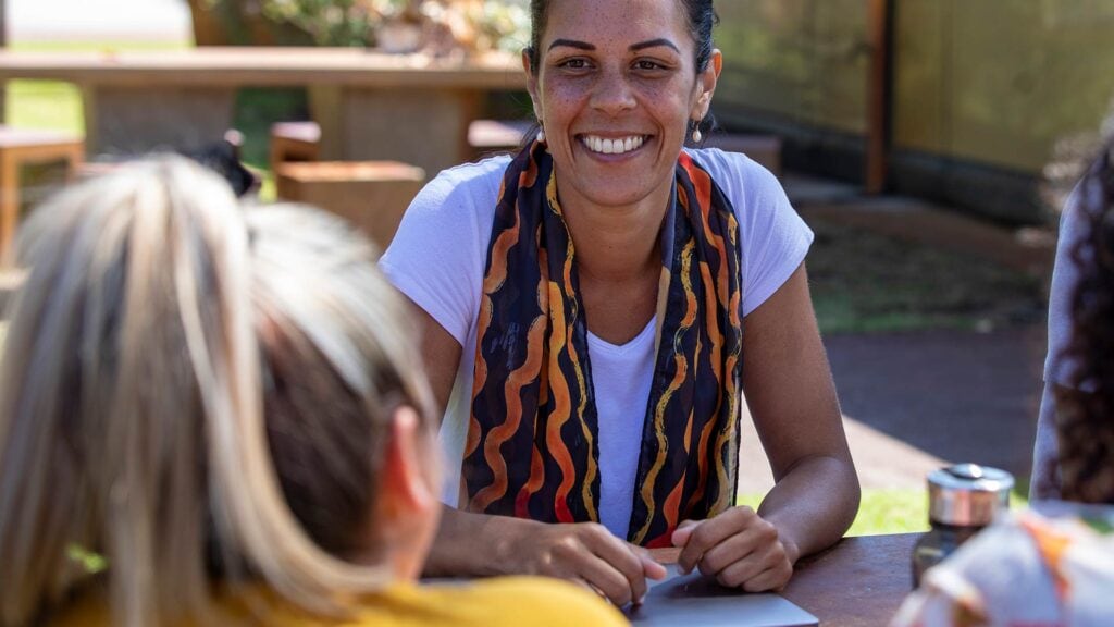 Woman talking to young girl in a friendly manner